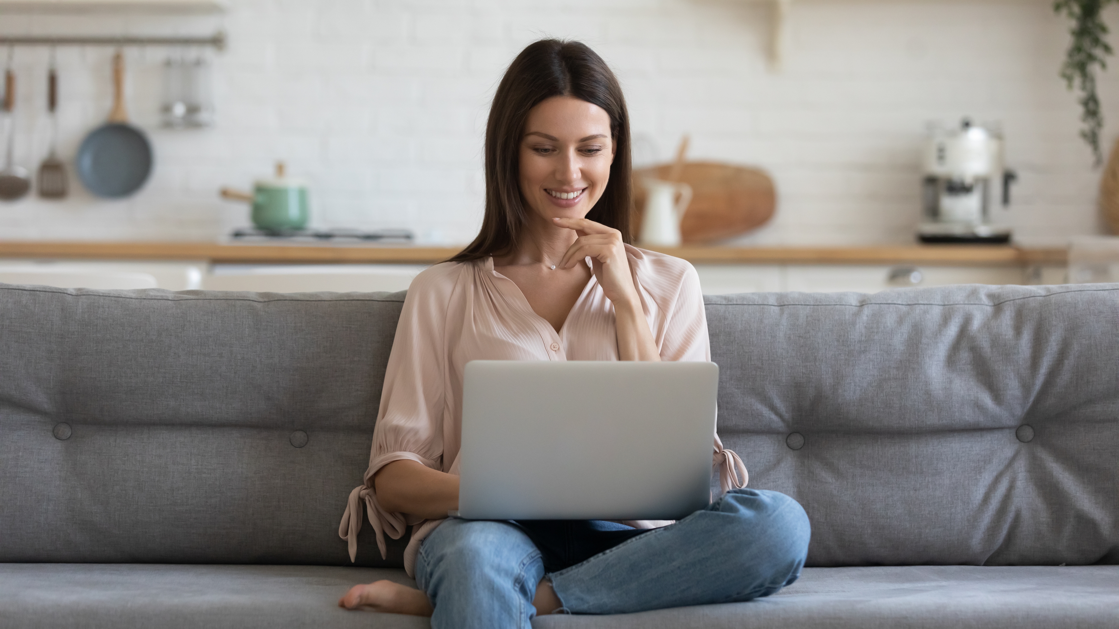 Woman sitting on chair using laptop