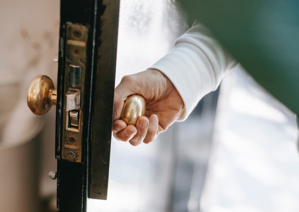 Holding door handle and opening door.