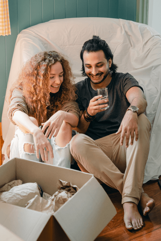 Couple laughing after moving house